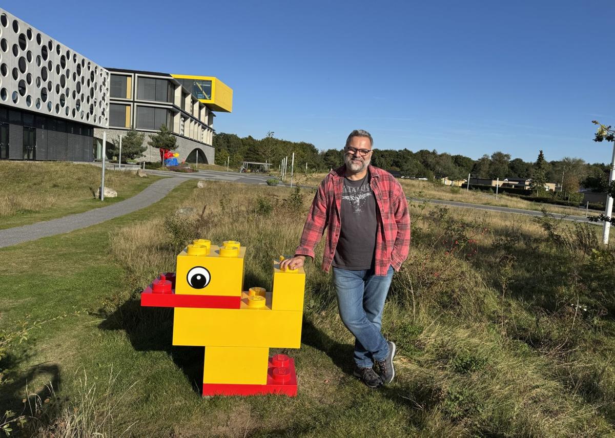 Özgür Poyrazoğlu next to a giant brick duck at LEGO Campus in Billund